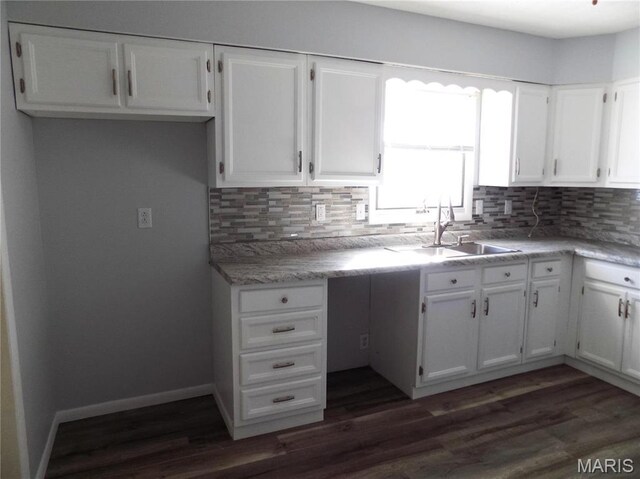 1306 Broadway St, Rolla, MO 65401 - kitchen featuring white cabinets, tasteful backsplash, dark wood-type flooring, and a sink