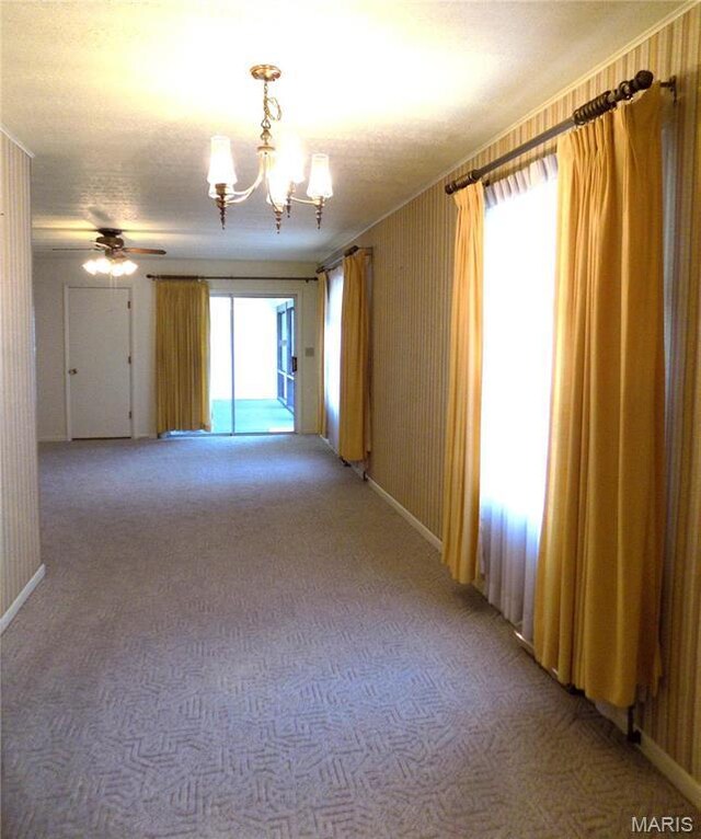 1306 Broadway St, Rolla, MO 65401 - unfurnished room featuring a chandelier, light carpet, a textured ceiling, and baseboards
