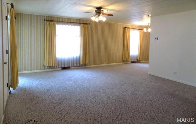 1306 Broadway St, Rolla, MO 65401 - spare room with a ceiling fan, carpet, baseboards, and a chandelier