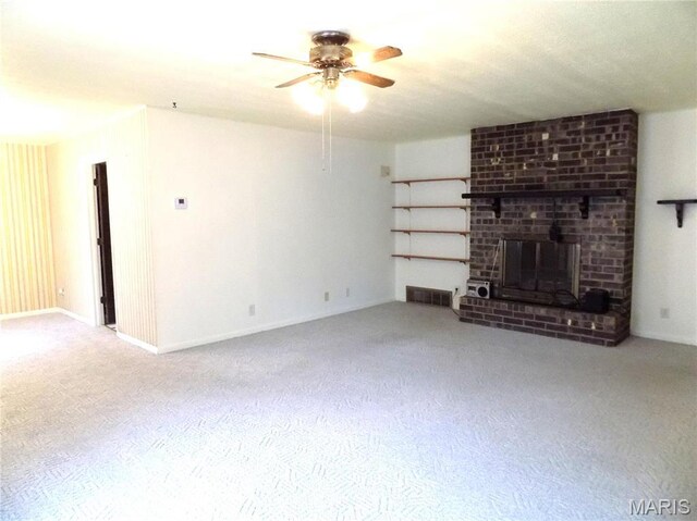 1306 Broadway St, Rolla, MO 65401 - unfurnished living room featuring carpet flooring, ceiling fan, a fireplace, and baseboards