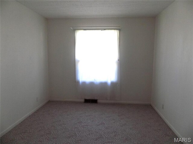 1306 Broadway St, Rolla, MO 65401 - empty room with light colored carpet and baseboards