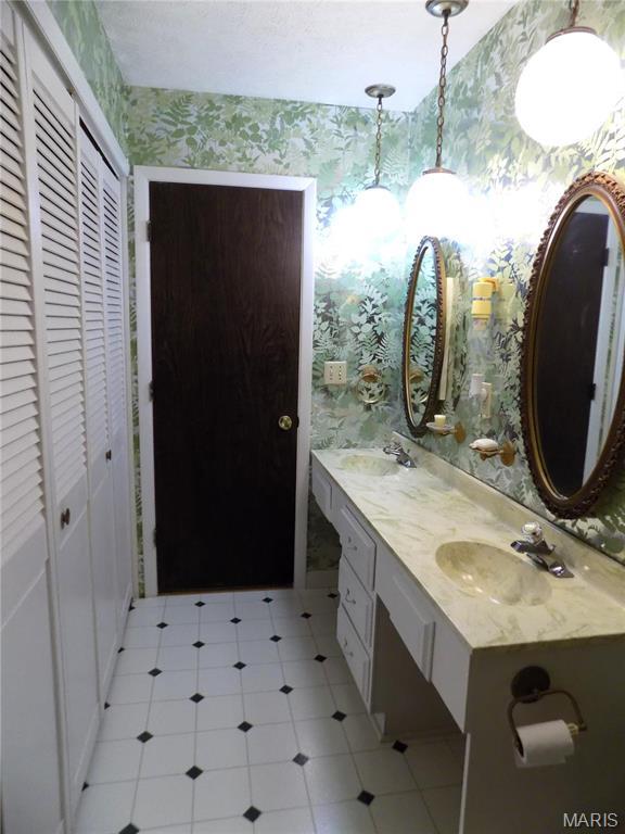 1306 Broadway St, Rolla, MO 65401 - full bathroom with wallpapered walls, a closet, and double vanity