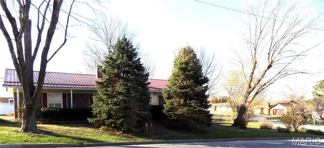 1306 Broadway St, Rolla, MO 65401 - view of side of home featuring a chimney and metal roof