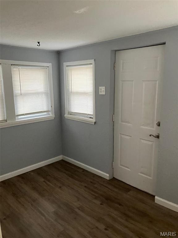 708 E Pear Ave, Owensville, MO 65066 - unfurnished room featuring dark wood finished floors and baseboards