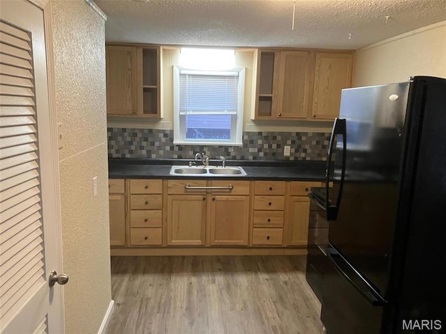 708 E Pear Ave, Owensville, MO 65066 - kitchen with freestanding refrigerator, a sink, open shelves, light wood-type flooring, and a textured ceiling