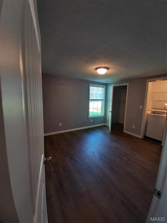 708 E Pear Ave, Owensville, MO 65066 - empty room featuring wood finished floors, baseboards, and a textured ceiling