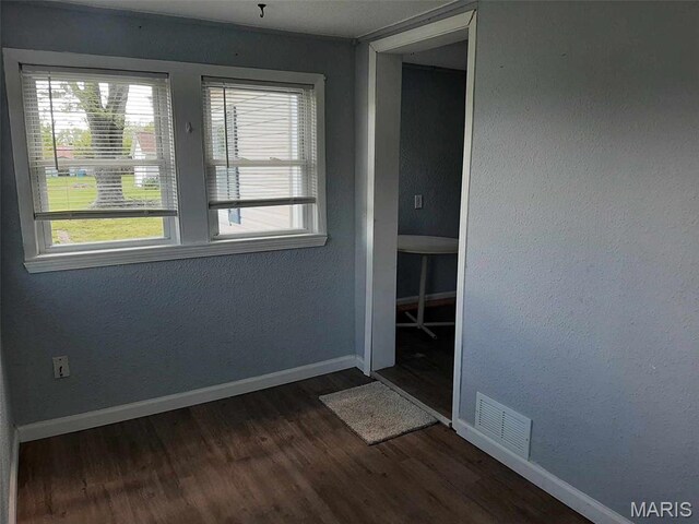 708 E Pear Ave, Owensville, MO 65066 - empty room featuring dark wood-style floors and baseboards