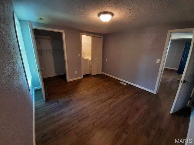 708 E Pear Ave, Owensville, MO 65066 - unfurnished bedroom featuring a textured ceiling, dark wood-style floors, a closet, and baseboards