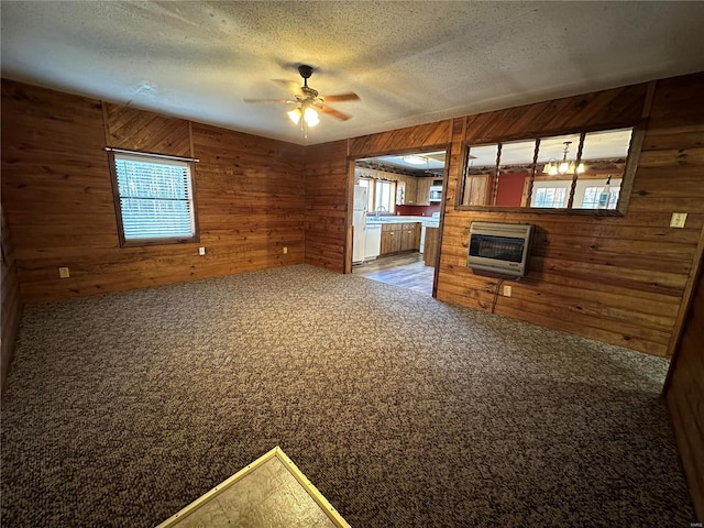 4117 State Highway 21, Grandin, MO 63943 - unfurnished living room with wooden walls, heating unit, a ceiling fan, a glass covered fireplace, and carpet