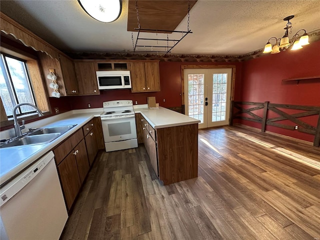 4117 State Highway 21, Grandin, MO 63943 - kitchen featuring white appliances, a sink, a peninsula, dark wood-style flooring, and french doors