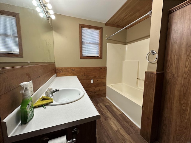 4117 State Highway 21, Grandin, MO 63943 - full bathroom featuring wood finished floors, wainscoting, shower / tub combination, vanity, and wooden walls