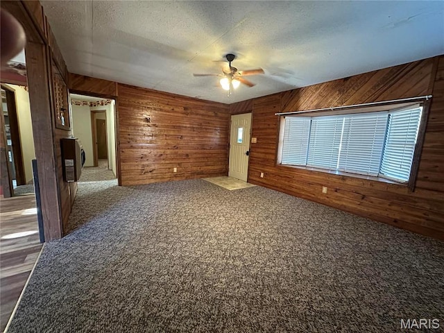 4117 State Highway 21, Grandin, MO 63943 - carpeted spare room with a ceiling fan, wood walls, and a textured ceiling