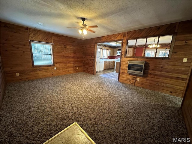 4117 State Highway 21, Grandin, MO 63943 - unfurnished living room featuring wooden walls, heating unit, a ceiling fan, carpet flooring, and a glass covered fireplace