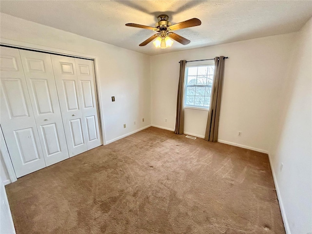 502 Mcclaren Way, Dixon, MO 65459 - unfurnished bedroom with carpet floors, a closet, baseboards, and a ceiling fan