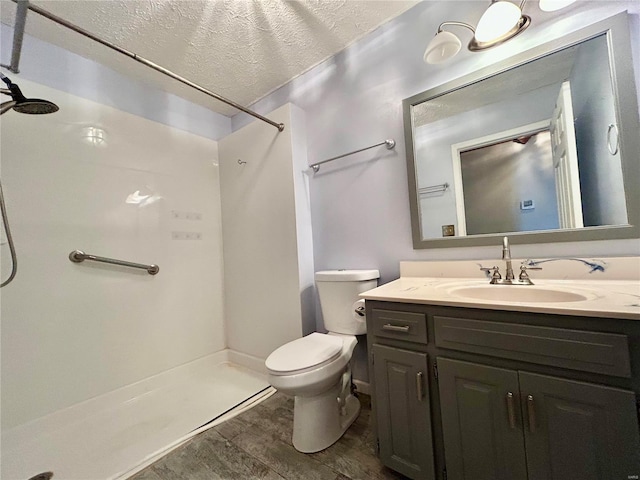 502 Mcclaren Way, Dixon, MO 65459 - full bathroom with wood finished floors, a shower, toilet, vanity, and a textured ceiling