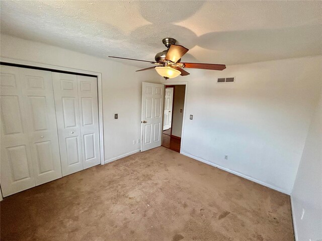 502 Mcclaren Way, Dixon, MO 65459 - unfurnished bedroom featuring light carpet, a closet, baseboards, and a ceiling fan