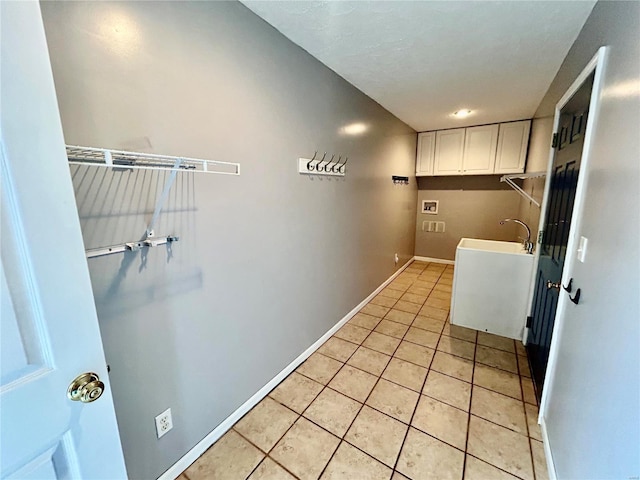 502 Mcclaren Way, Dixon, MO 65459 - laundry area featuring washer hookup, cabinet space, light tile patterned floors, and baseboards