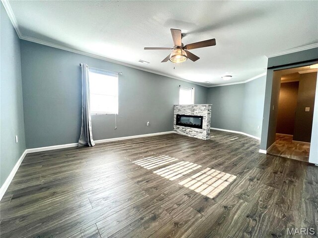792 County Road 466, Poplar Bluff, MO 63901 - unfurnished living room featuring ornamental molding, ceiling fan, a glass covered fireplace, baseboards, and dark wood finished floors