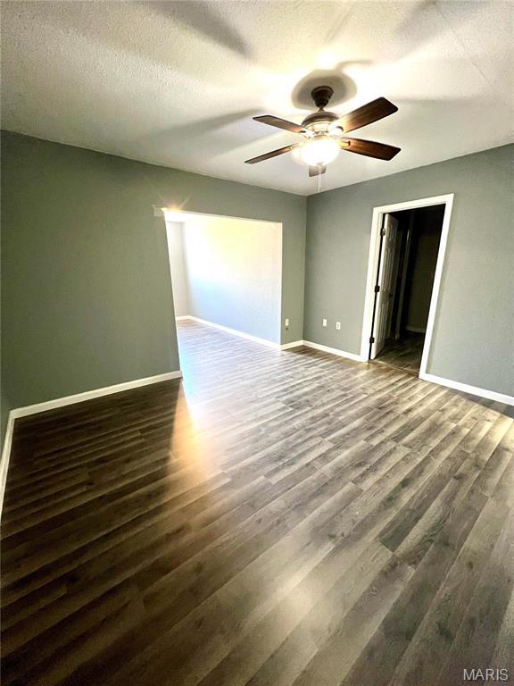 792 County Road 466, Poplar Bluff, MO 63901 - empty room with ceiling fan, dark wood-style floors, baseboards, and a textured ceiling