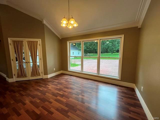 15800 State Highway Ad, Dexter, MO 63841 - empty room with a chandelier, ornamental molding, vaulted ceiling, dark wood-style flooring, and baseboards