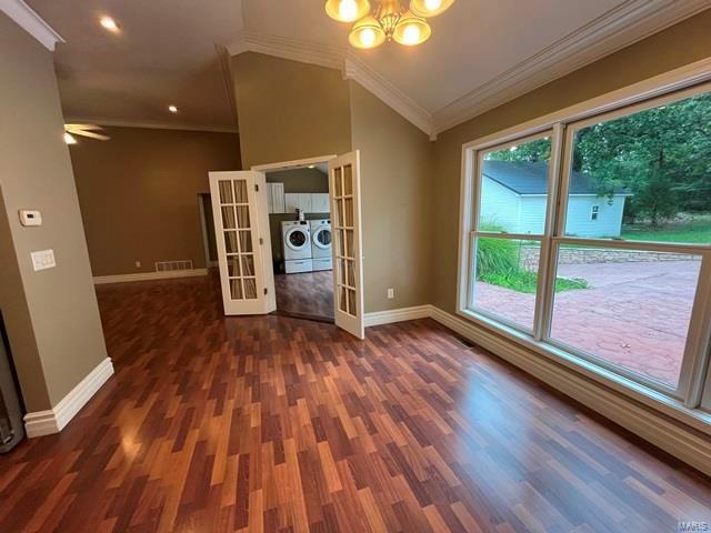 15800 State Highway Ad, Dexter, MO 63841 - spare room with french doors, washing machine and clothes dryer, baseboards, ornamental molding, and wood finished floors