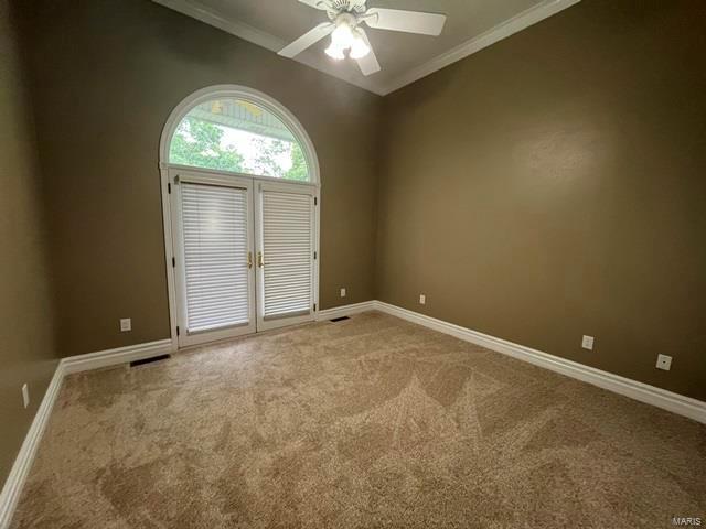 15800 State Highway Ad, Dexter, MO 63841 - spare room featuring carpet flooring, crown molding, a ceiling fan, and baseboards