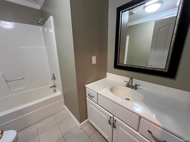 15800 State Highway Ad, Dexter, MO 63841 - full bathroom featuring ornamental molding, vanity, shower / bath combination, tile patterned flooring, and baseboards