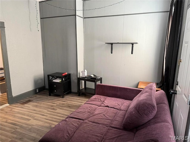 bedroom with wood finished floors and baseboards
