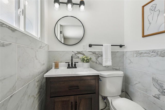 11567 Joslyn Ct, Saint Louis, MO 63138 - half bathroom with vanity, toilet, tile walls, and a wainscoted wall