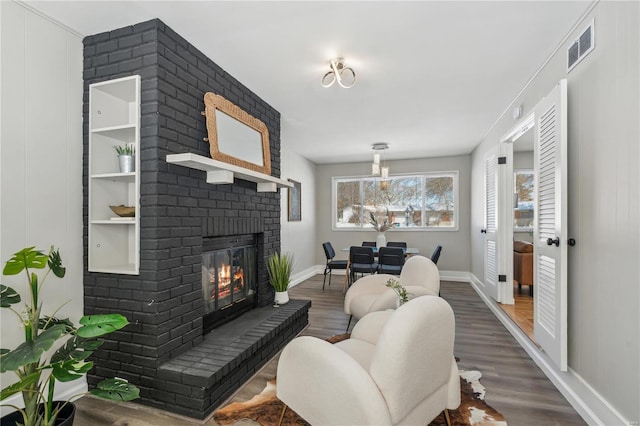 11567 Joslyn Ct, Saint Louis, MO 63138 - living room with a fireplace, baseboards, and wood finished floors