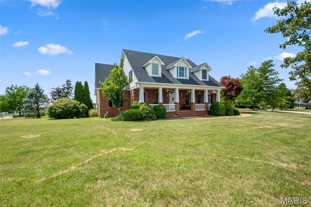 850 Aj Farm Ln, Washington, MO 63090 - cape cod-style house featuring a porch, brick siding, and a front yard