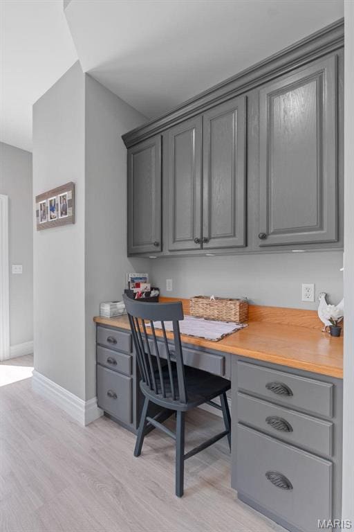 850 Aj Farm Ln, Washington, MO 63090 - office area with light wood finished floors, baseboards, and built in desk