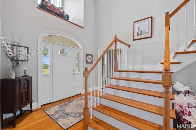 850 Aj Farm Ln, Washington, MO 63090 - entryway featuring stairs, wood finished floors, a towering ceiling, and baseboards