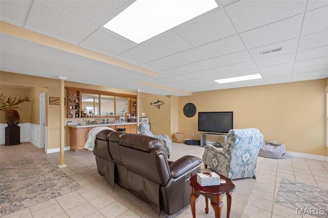 850 Aj Farm Ln, Washington, MO 63090 - living area featuring a paneled ceiling, light tile patterned floors, and bar