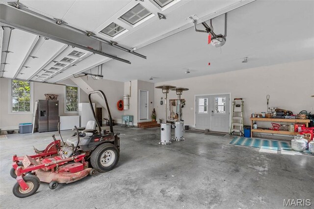 850 Aj Farm Ln, Washington, MO 63090 - garage featuring a garage door opener and stainless steel fridge with ice dispenser