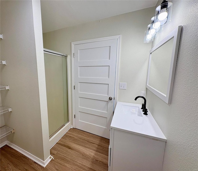 813 Breeze Ct, Perryville, MO 63775 - full bathroom with wood finished floors, a stall shower, vanity, and baseboards