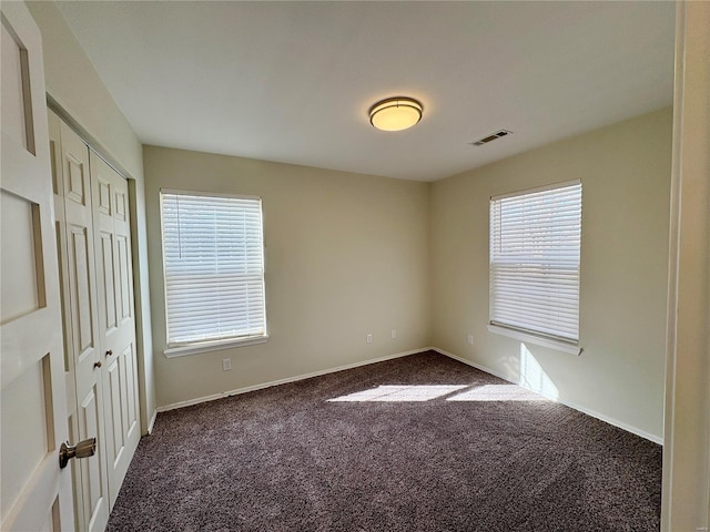 813 Breeze Ct, Perryville, MO 63775 - unfurnished bedroom featuring dark carpet and baseboards