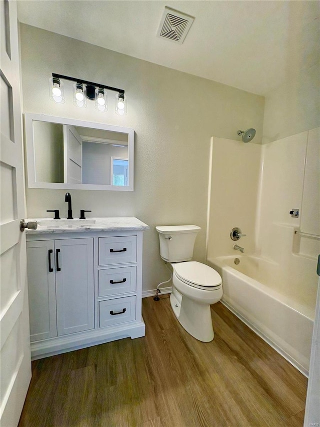 813 Breeze Ct, Perryville, MO 63775 - bathroom featuring wood finished floors, toilet, vanity, bathing tub / shower combination, and baseboards