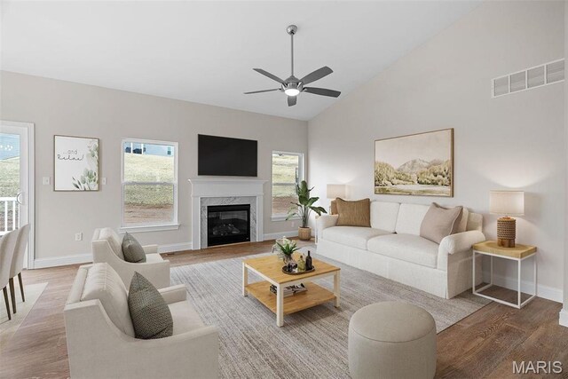 2995 Halls Green Dr, Washington, MO 63090 - living area featuring wood finished floors, healthy amount of natural light, a ceiling fan, baseboards, and high vaulted ceiling