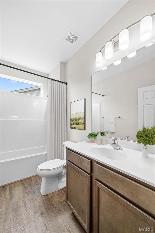 2995 Halls Green Dr, Washington, MO 63090 - full bath with wood finished floors, vanity, toilet, and shower / bath combination with curtain