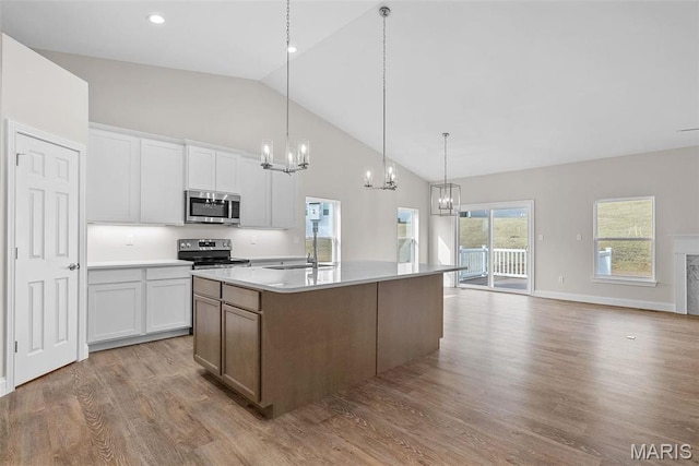 2995 Halls Green Dr, Washington, MO 63090 - kitchen with appliances with stainless steel finishes, a chandelier, a sink, high vaulted ceiling, and light wood-style floors