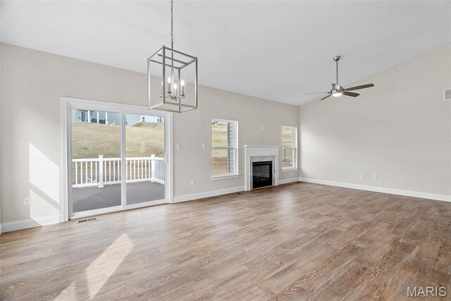 2995 Halls Green Dr, Washington, MO 63090 - unfurnished living room with wood finished floors, ceiling fan, plenty of natural light, and vaulted ceiling