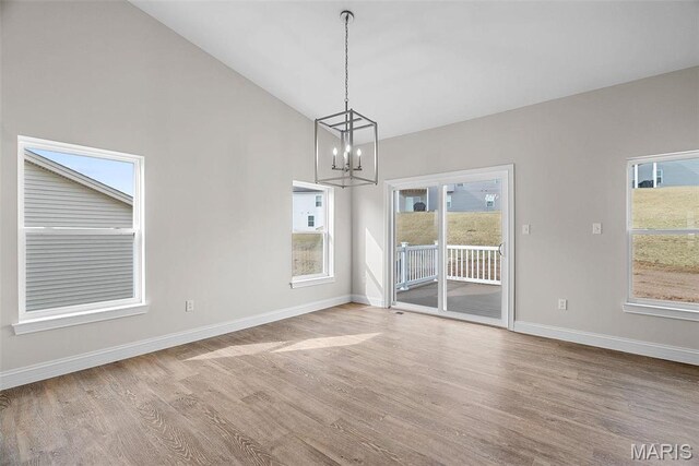 2995 Halls Green Dr, Washington, MO 63090 - unfurnished dining area with a chandelier, wood finished floors, baseboards, and lofted ceiling