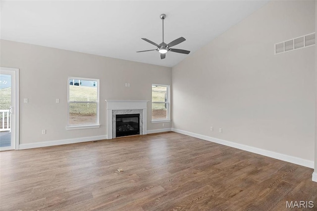 2995 Halls Green Dr, Washington, MO 63090 - unfurnished living room featuring healthy amount of natural light, a ceiling fan, wood finished floors, vaulted ceiling, and baseboards