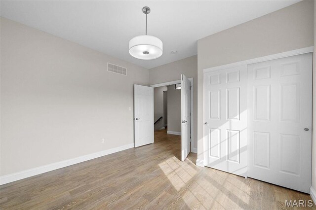 2995 Halls Green Dr, Washington, MO 63090 - unfurnished bedroom featuring light wood-style floors, baseboards, and a closet