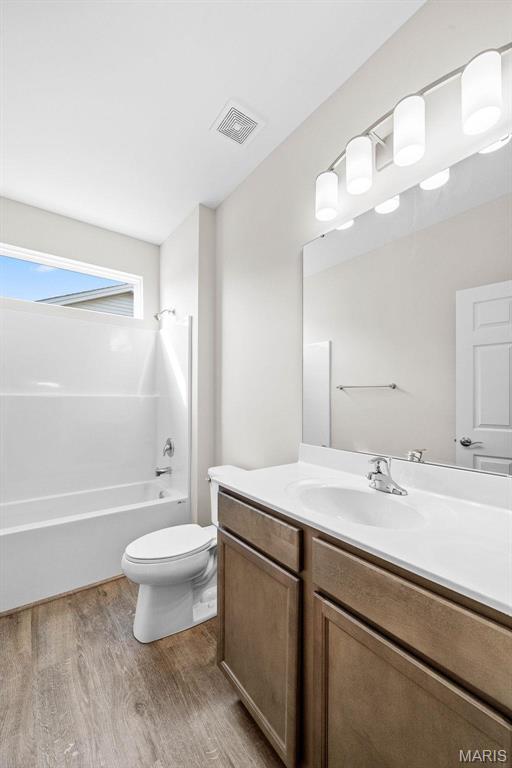 2995 Halls Green Dr, Washington, MO 63090 - full bathroom with wood finished floors, vanity, toilet, and shower / washtub combination