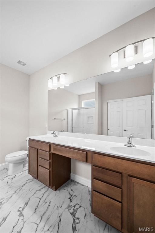 2995 Halls Green Dr, Washington, MO 63090 - bathroom with double vanity, a shower stall, and marble finish floors