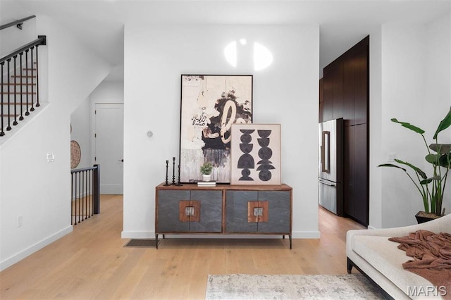 215 N Sarah St Unit 13, Saint Louis, MO 63108 - hall featuring light wood-style floors, stairway, and baseboards