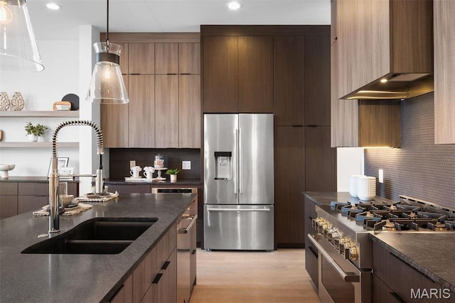215 N Sarah St Unit 13, Saint Louis, MO 63108 - kitchen featuring appliances with stainless steel finishes, a sink, modern cabinets, wall chimney range hood, and backsplash