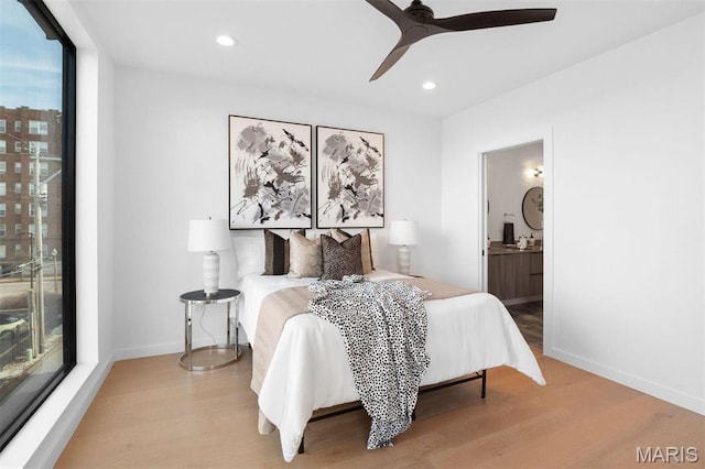 215 N Sarah St Unit 13, Saint Louis, MO 63108 - bedroom featuring light wood finished floors, connected bathroom, recessed lighting, baseboards, and multiple windows